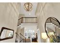 Bright foyer featuring tall ceilings, hardwood floors, and a view into the open-concept living area at 2071 Eagle Trace Dr, Greenwood, IN 46143
