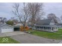 Charming home with a covered porch, detached garage and long driveway, offering both curb appeal and convenience at 401 E Ohio St, Fortville, IN 46040