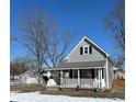 Charming two-story home featuring a quaint covered porch and detached garage at 401 E Ohio St, Fortville, IN 46040