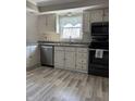 Well-lit kitchen with modern appliances, ample cabinet space, and stylish flooring at 401 E Ohio St, Fortville, IN 46040