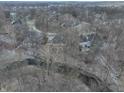 Panoramic aerial view of a neighborhood with homes nestled among trees and a stream running through it at 4388 Creekside Pass, Zionsville, IN 46077