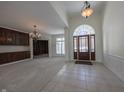 Elegant foyer with tile flooring, a dark wood front door, and open access to adjacent living spaces at 4388 Creekside Pass, Zionsville, IN 46077
