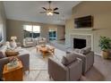 Bright living room with a ceiling fan, fireplace, plush seating, and view to the outdoor patio at 5251 Rocky Mountain Dr, Indianapolis, IN 46237