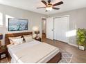Cozy bedroom with hardwood floors, a ceiling fan, and a modern bed frame, creating a relaxing retreat at 6130 Midway Ct, Indianapolis, IN 46224