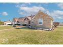 Attractive ranch home boasts mature trees, a basketball hoop, and a serene country setting at 7705 N State Road 42, Stilesville, IN 46180