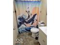 Quirky bathroom features a playful shower curtain and white fixtures at 8353 Paso Del Norte Ct, Indianapolis, IN 46227