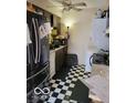 Functional kitchen space with essential appliances and checkered flooring at 8353 Paso Del Norte Ct, Indianapolis, IN 46227