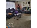 Relaxing living room setup with comfortable seating and large windows at 8353 Paso Del Norte Ct, Indianapolis, IN 46227