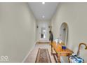 Bright hallway featuring tiled floors, classic decor, and a welcoming atmosphere at 8429 Quail Hollow Rd, Indianapolis, IN 46260