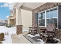 Cozy front porch with brick columns and wooden rocking chairs, perfect for enjoying the outdoors at 9711 Pica Dr, Fishers, IN 46040
