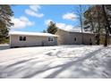 Rear exterior view of the home with a large backyard and lots of snow covering the ground at 9800 N Gasburg Rd, Mooresville, IN 46158