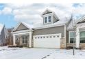 Home with a covered front porch, brick accents, two-car garage, and a dormer on the roof at 10178 Bolcom Ct, Noblesville, IN 46060