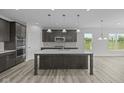 Modern kitchen featuring a large island, stainless steel appliances, and pendant lighting at 10502 Oak Bend Blvd, Indianapolis, IN 46239