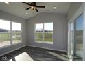 Bright sunroom with large windows offering picturesque views of the surrounding landscape and plank flooring at 10502 Oak Bend Blvd, Indianapolis, IN 46239