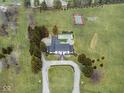 An aerial view of the property, highlighting the house, pool, tennis court, and manicured grounds at 11120 Queens Way Cir, Carmel, IN 46032