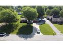 Aerial view of a suburban home with a lush green lawn and mature trees at 1231 S Catherwood Ave, Indianapolis, IN 46203