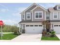 Charming two-story townhome with attached garage, stone accents, and manicured lawn at 1249 Langham St, Avon, IN 46123