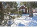 View of a brick home with white trim, surrounded by snow and trees at 1701 Broad Ripple Ave, Indianapolis, IN 46220