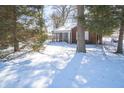 Brick home with a screened-in porch and snow covered yard at 1701 Broad Ripple Ave, Indianapolis, IN 46220