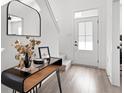 Bright foyer showcasing a sleek console table with decorative elements and a view of the staircase at 1842 Milburn St, Indianapolis, IN 46202