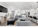 Open-concept living room with a plush sectional sofa, leading into a modern kitchen and dining area at 1842 Milburn St, Indianapolis, IN 46202