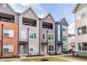 Contemporary townhomes with balconies and colorful facades create inviting curb appeal at 2115 Coretta Way, Indianapolis, IN 46202