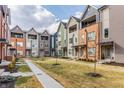 Street view of townhouses with neat lawns and sidewalks offering a walkable community vibe at 2115 Coretta Way, Indianapolis, IN 46202