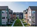 Scenic aerial view of colorful townhomes showcasing landscaping and community green space at 2139 Coretta Way, Indianapolis, IN 46202