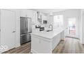 Bright kitchen features stainless appliances, white cabinets, and a spacious island at 2139 Coretta Way, Indianapolis, IN 46202