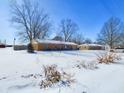 Single story home with brick exterior surrounded by snowy yard and bare trees at 2749 W 900 S, Pendleton, IN 46064