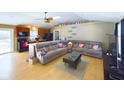 Open living room and kitchen featuring a large gray sectional and wood floors at 2749 W 900 S, Pendleton, IN 46064