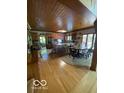 Spacious kitchen with wood cabinets, a large island, and a round dining table at 3932 W Poplar Point Ct, Trafalgar, IN 46181
