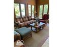 Cozy living room with comfortable seating and natural light from large windows at 3932 W Poplar Point Ct, Trafalgar, IN 46181