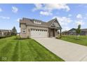 Charming single-story home with brick facade, attached garage, and manicured lawn at 5040 Carmine St, Brownsburg, IN 46112