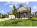Charming single-story home with brick facade, attached garage, and manicured lawn at 5040 Carmine St, Brownsburg, IN 46112