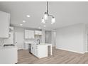 Well-lit kitchen showcases an island with a sink, stainless steel appliances, and modern fixtures at 5040 Carmine St, Brownsburg, IN 46112