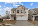 Inviting two-story home with attached garage, featuring a classic facade and well-manicured driveway at 5119 Rolling Meadow Blvd, Indianapolis, IN 46237