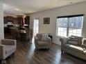 Open-concept living room and dining area with wood floors and natural light from a window at 5120 Maywood Dr, Whitestown, IN 46075