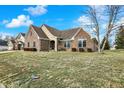 Charming brick home featuring manicured landscaping at 6014 Easy Ln, Indianapolis, IN 46259