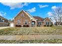 Charming brick home featuring manicured landscaping and a sidewalk at 6014 Easy Ln, Indianapolis, IN 46259