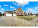 A charming home with an attached two car garage and long drive way at 6014 Easy Ln, Indianapolis, IN 46259