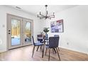 Cozy dining room with modern lighting and access to the outdoors at 6784 Stanhope Way, Indianapolis, IN 46254