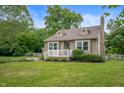 Charming home featuring a well-manicured lawn, neutral siding, and inviting front porch at 6865 Meadow View Dr, Lawrence, IN 46226