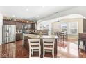 Open kitchen with granite countertops, stainless steel appliances, and a breakfast bar at 7559 Pacific Summit, Noblesville, IN 46062