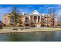 Inviting brick condo with columns and waterfront views on a sunny day at 8690 Jaffa Ct W Dr # 18, Indianapolis, IN 46260