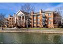 An inviting brick condo with balconies, columns, and waterfront views at 8690 Jaffa Ct W Dr # 18, Indianapolis, IN 46260
