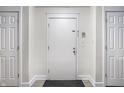 A bright hallway with neutral walls features three white doors at 8690 Jaffa Ct W Dr # 18, Indianapolis, IN 46260