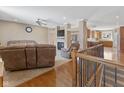 Open-concept living room with fireplace, neutral carpet, and a seamless flow into the kitchen area at 11 Stratford Way, Danville, IN 46122
