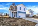 Inviting two-story home featuring a blue and white facade, attached garage, and newly landscaped front yard at 11711 Cotterill Way, Indianapolis, IN 46235