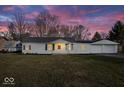 Charming single-story home featuring a well-maintained lawn and an attached two-car garage at 1408 W Banta Rd, Indianapolis, IN 46217